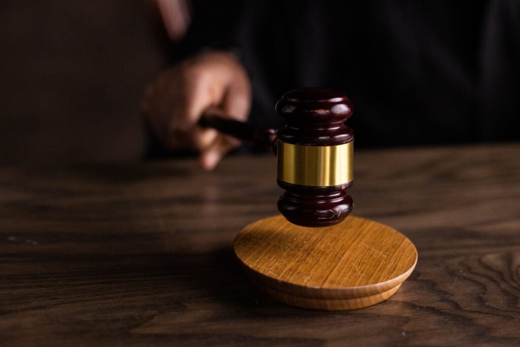 Close-up of a brown wooden gavel on a matching table, symbolizing arbitration and justice.